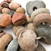 Closeup photo of antique granite stones beads on rope